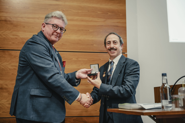 A person receiving an award in the Maurice Bloch Lecture Theatre 